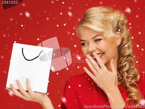 Image of lovely woman in red dress with shopping bag