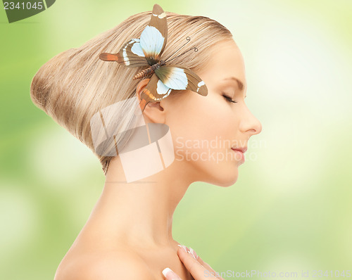 Image of woman with butterfly in hair