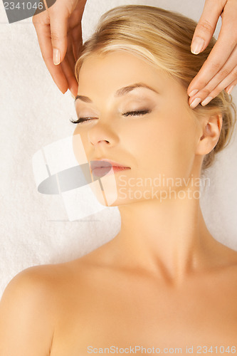 Image of beautiful woman in massage salon