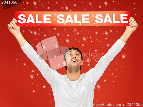 Image of handsome man with sale sign