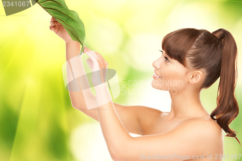 Image of woman with green leaf