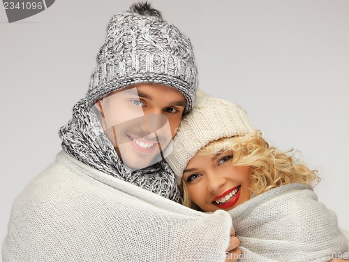 Image of family couple under warm blanket