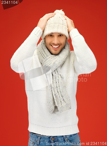 Image of handsome man in warm sweater, hat and scarf