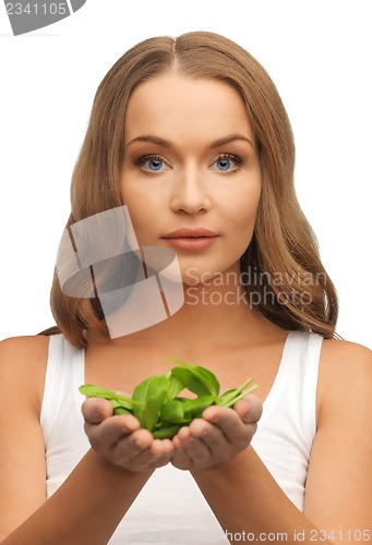 Image of woman with spinach leaves on palms
