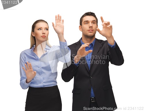 Image of man and woman working with something imaginary