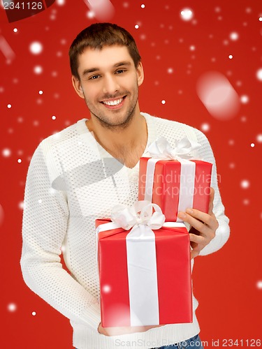 Image of man holding many gift boxes