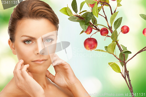 Image of lovely woman with apple twig