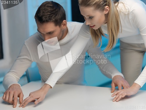 Image of man and woman working with something