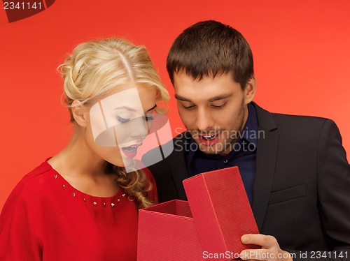 Image of man and woman looking inside the gift box
