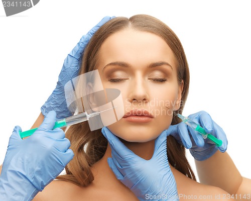 Image of woman face and beautician hands