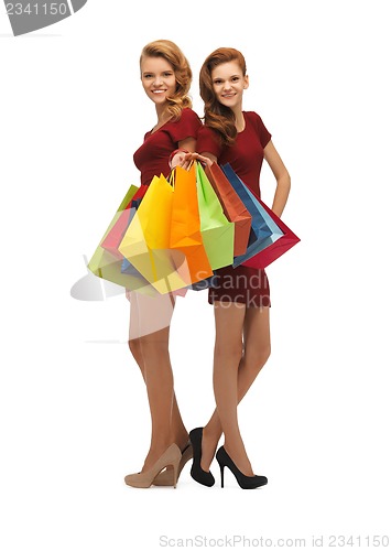 Image of teenage girls in red dresses with shopping bags