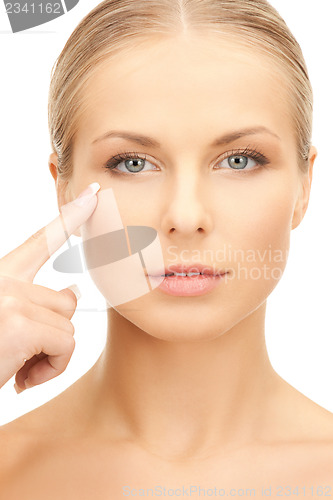 Image of beautiful woman pointing to cheek