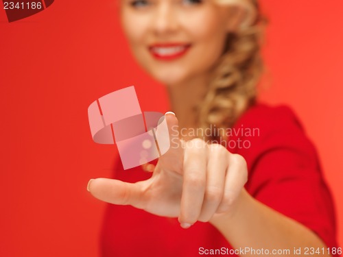 Image of woman in red dress pressing virtual button