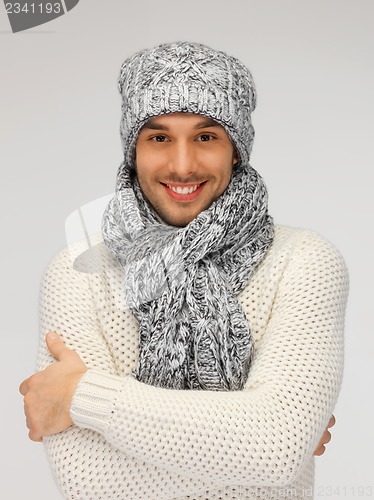 Image of handsome man in warm sweater, hat and scarf