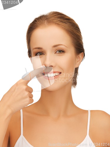 Image of beautiful woman pointing to nose