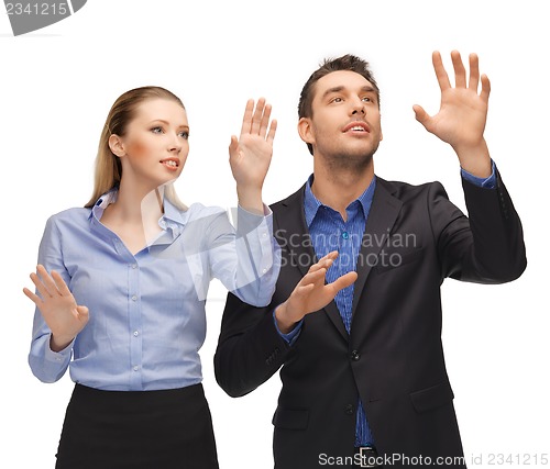Image of man and woman working with something imaginary