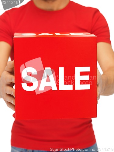 Image of man holding sale sign