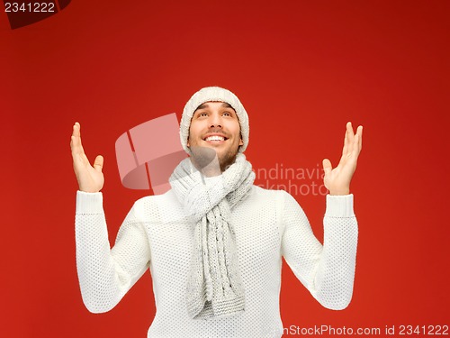 Image of handsome man in warm sweater, hat and scarf