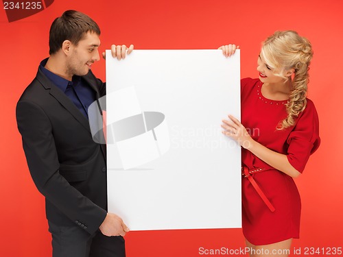 Image of couple holding big blank board