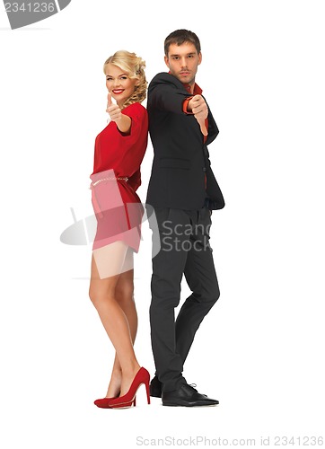 Image of man and woman showing thumbs up, down