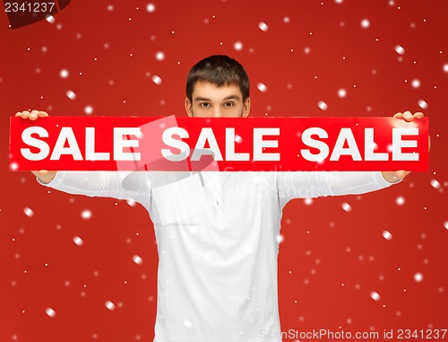 Image of man holding sale sign