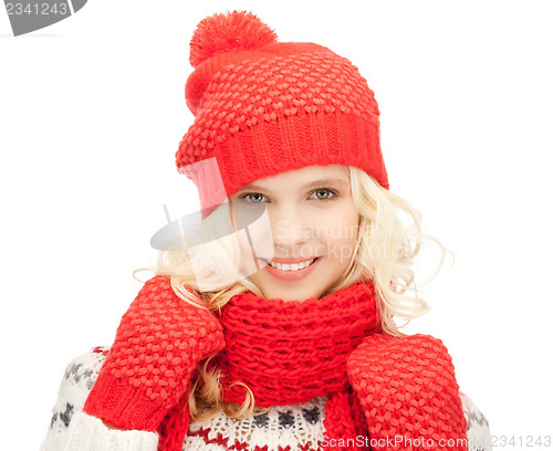 Image of beautiful woman in hat, muffler and mittens