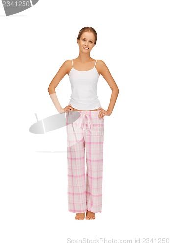 Image of happy and smiling woman in cotton pajamas