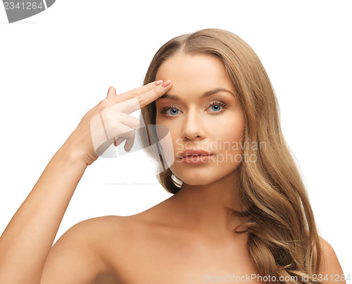 Image of beautiful woman pointing to forehead