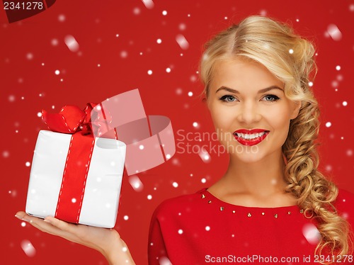 Image of lovely woman in red dress with present