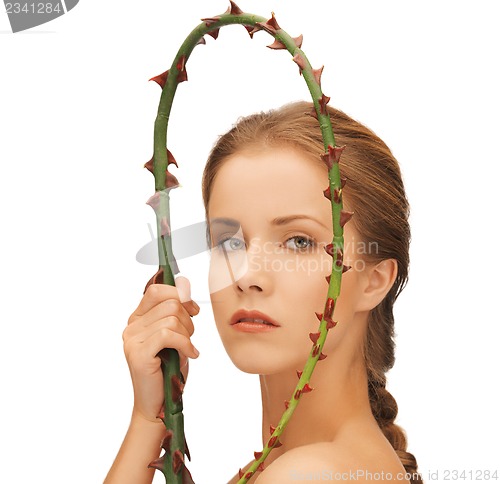 Image of woman holding branch with thorns