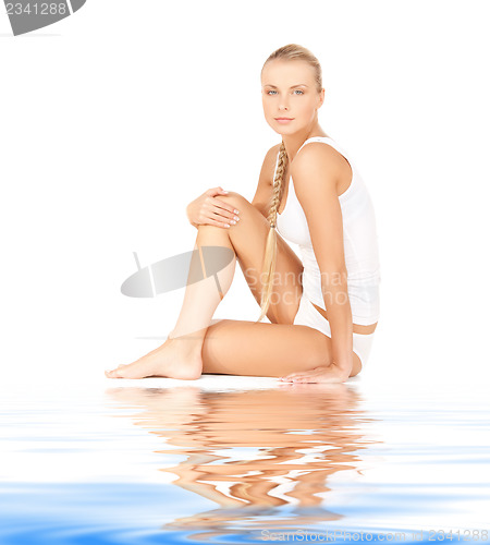 Image of beautiful woman in cotton undrewear on white sand