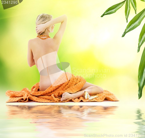 Image of beautiful lady with orange towels