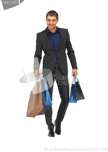 Image of handsome man in suit with shopping bags