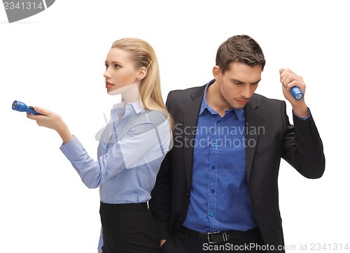 Image of man and woman with flashlights