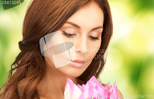 Image of beautiful woman with lotus flower