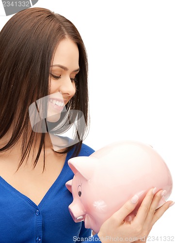 Image of lovely woman with piggy bank