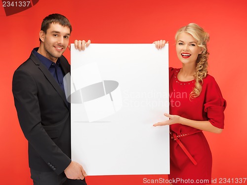 Image of couple holding big blank board