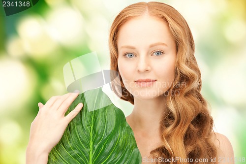 Image of woman with green leaf