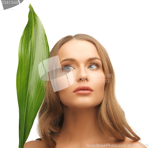 Image of woman with green leaf
