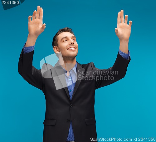 Image of man in suit working with something imaginary