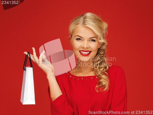 Image of lovely woman in red dress with shopping bag