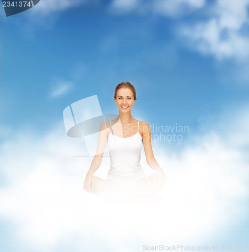 Image of woman practicing yoga lotus pose