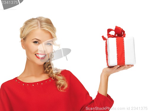 Image of lovely woman in red dress with present