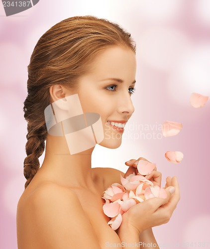 Image of beautiful woman with rose petals