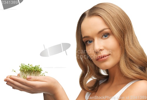Image of woman with green grass on palms