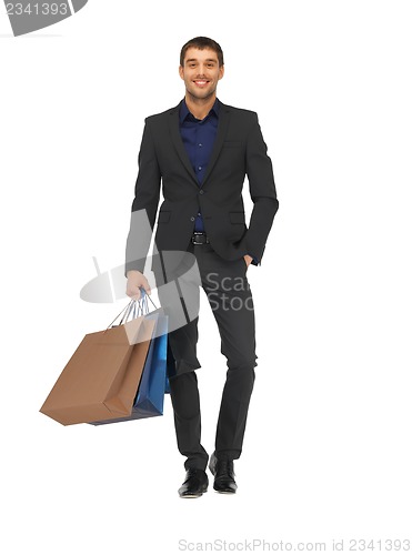 Image of handsome man in suit with shopping bags