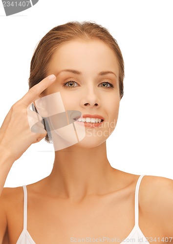 Image of beautiful woman pointing to eyebrow