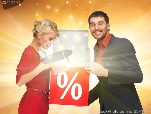 Image of man and woman with percent sign