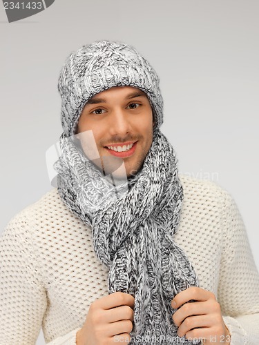 Image of handsome man in warm sweater, hat and scarf