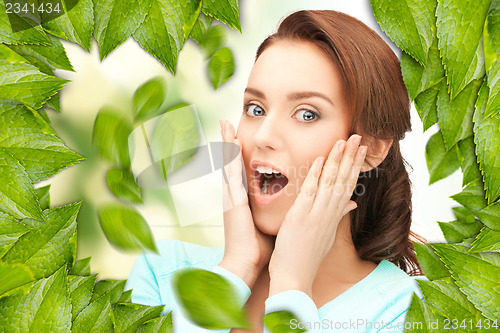 Image of beautiful woman with green leaves